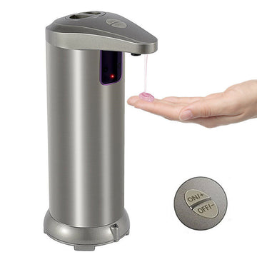Silver automatic soap dispenser dispensing soap onto a hand