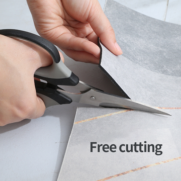 Person using scissors to cut a bathmat with text 'Free cutting' on a light background