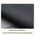 Black textured mat with non-slip bottom on a gray surface