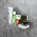 Wall-mounted shower caddy with various shampoo and bathroom bottles on a gray concrete wall