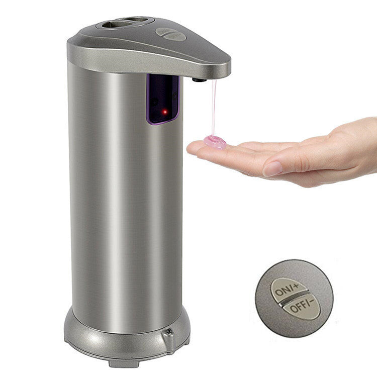 Silver automatic soap dispenser dispensing soap onto a hand