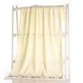White-colored blanket draped over a white rack on a white background