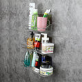 Wall-mounted metal shelf with various toiletries on a gray concrete wall.