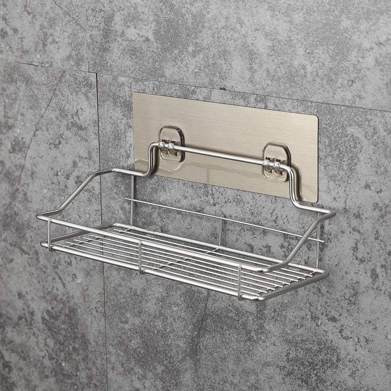 Metal wall-mounted shelf attached to a gray tiled wall