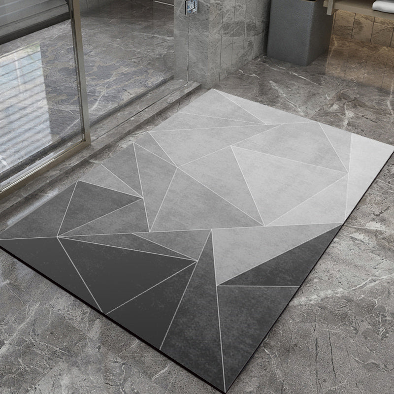 Geometric patterned bathmat on a stone floor