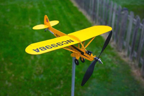 An Outdoor Garden Decorates An Airplane Weathervane