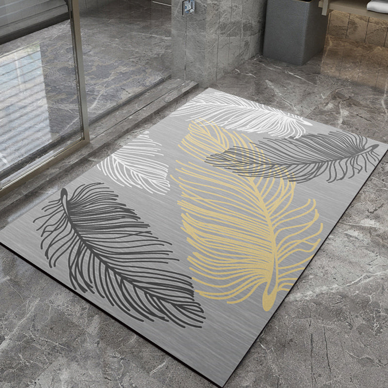 Decorative bathmat with leaf patterns on a stone floor