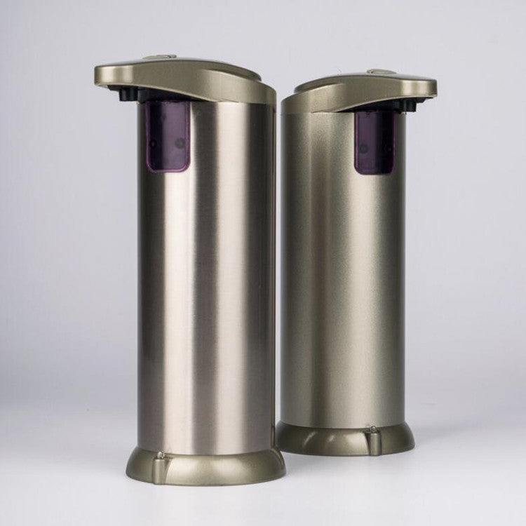 Silver automatic soap dispenser dispensing soap onto a hand