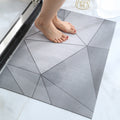 Person stepping onto a geometric-patterned bath mat